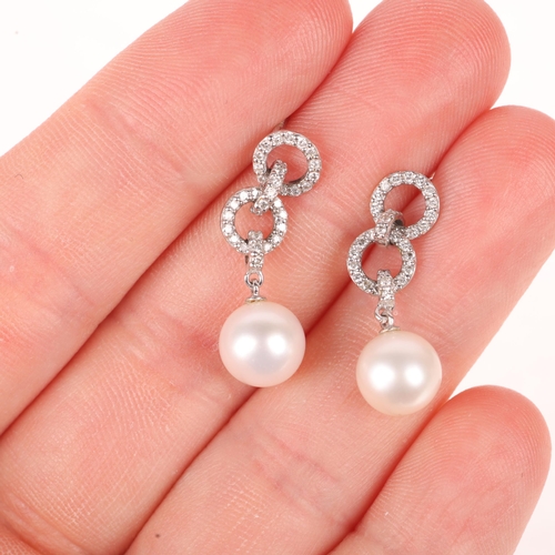 1105 - A pair of 18ct gold whole pearl and diamond drop stud earrings, each set with 7.7mm pearl suspended ... 