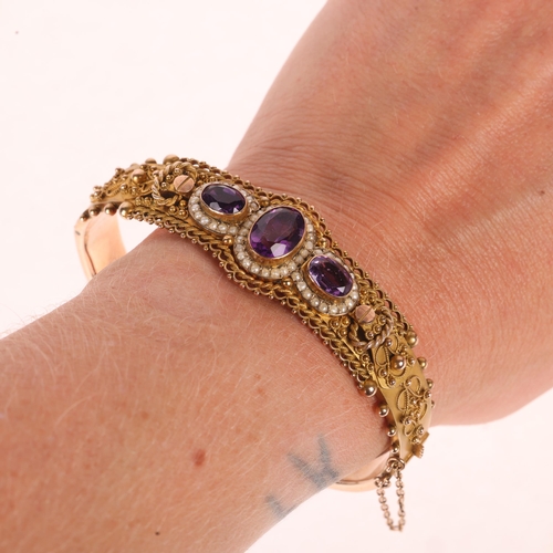 1110 - An Antique 9ct rose gold amethyst and split pearl Etruscan Revival hinged bangle, maker JS, Birmingh... 