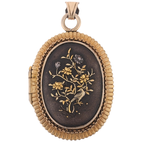 1114 - An Antique Japanese Meiji Period Shakudo locket pendant, circa 1890, with applied gold and silver de... 