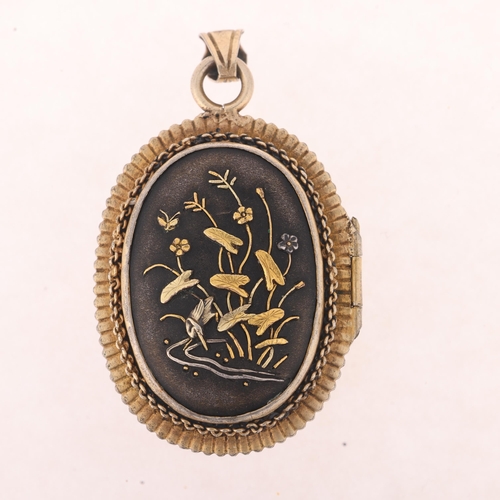 1114 - An Antique Japanese Meiji Period Shakudo locket pendant, circa 1890, with applied gold and silver de... 