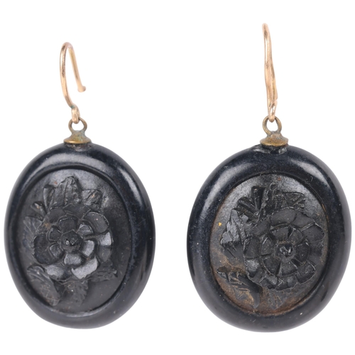 1115 - A pair of Victorian Whitby Jet drop earrings, relief carved floral decoration, with shepherd hook fi... 