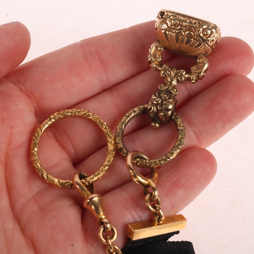 1121 - An Antique 15ct gold black silk watch fob chain, with hardstone intaglio seal fob and foliate split ... 