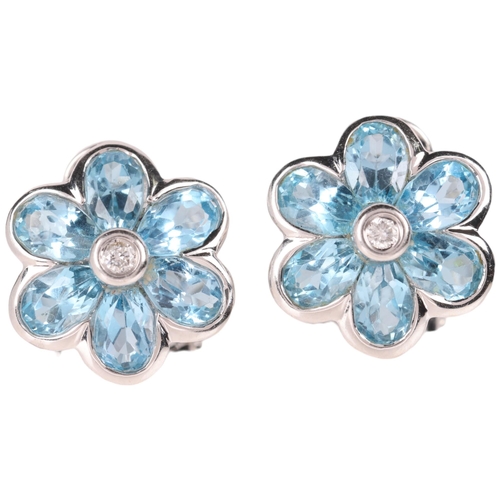 1141 - A pair of 18ct white gold blue topaz and diamond flowerhead cluster earrings, by Aura, set with pear... 