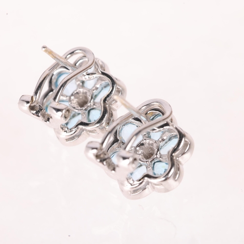 1141 - A pair of 18ct white gold blue topaz and diamond flowerhead cluster earrings, by Aura, set with pear... 