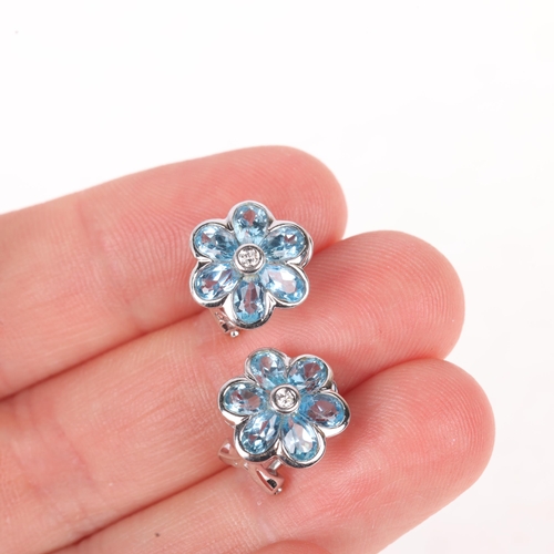 1141 - A pair of 18ct white gold blue topaz and diamond flowerhead cluster earrings, by Aura, set with pear... 