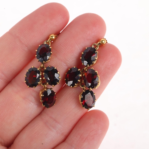 1143 - A pair of 9ct gold garnet drop earrings, set with oval mixed-cut garnets with screw-back fittings, 3... 