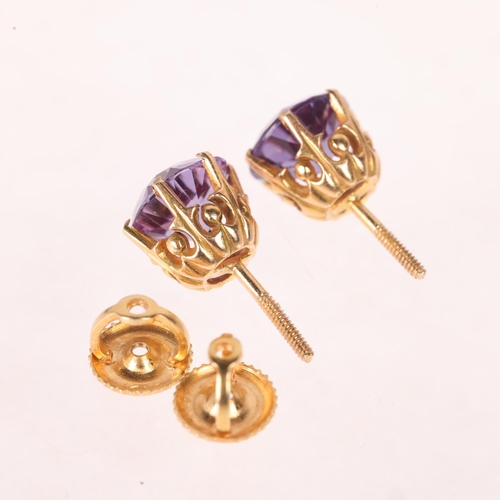 1148 - A pair of 14ct gold synthetic colour change sapphire stud earrings, unmarked mount tests as 14ct, 7.... 