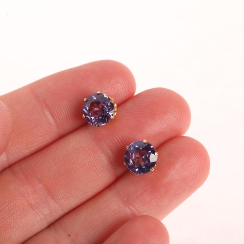 1148 - A pair of 14ct gold synthetic colour change sapphire stud earrings, unmarked mount tests as 14ct, 7.... 