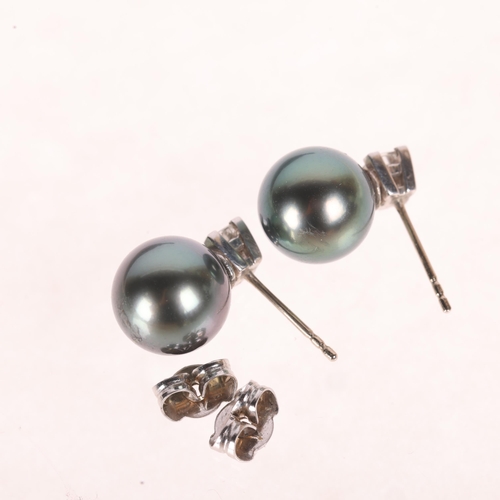 1171 - A Pair of Black Cultured Pearl and Diamond Stud Earrings,

each comprising a Princess-cut diamond su... 