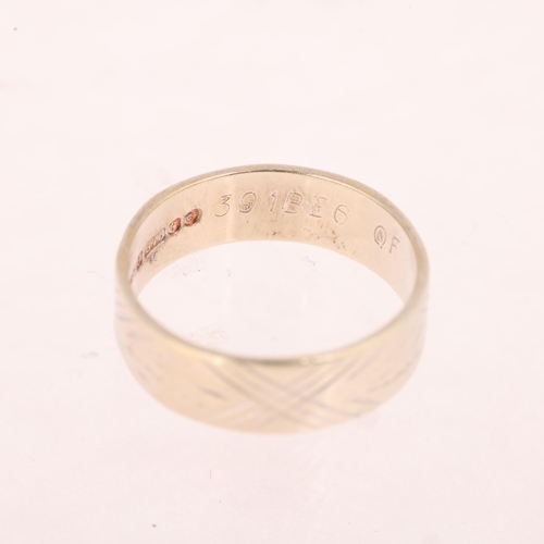 1186 - A 9ct white gold wedding band ring, maker BW & Sons, London 1971, engraved decoration, band width 6m... 