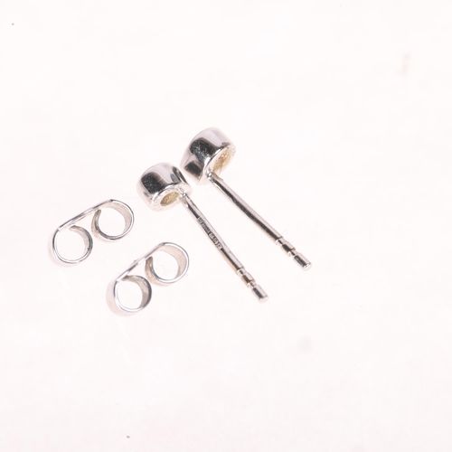 1207 - A pair of 18ct white gold diamond stud earrings, set with pear-cut diamonds, total diamond content a... 