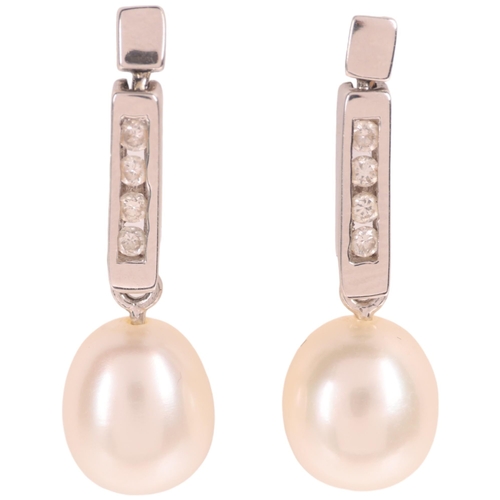 1209 - A pair 18ct white gold pearl and diamond stud earrings, set with 8.3mm pearls suspended from channel... 