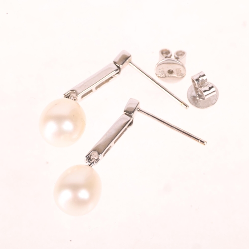 1209 - A pair 18ct white gold pearl and diamond stud earrings, set with 8.3mm pearls suspended from channel... 