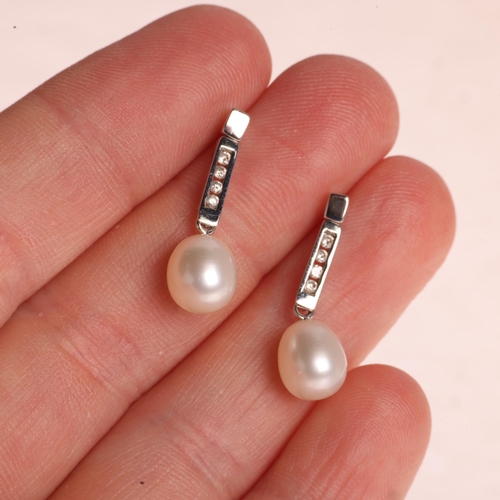 1209 - A pair 18ct white gold pearl and diamond stud earrings, set with 8.3mm pearls suspended from channel... 