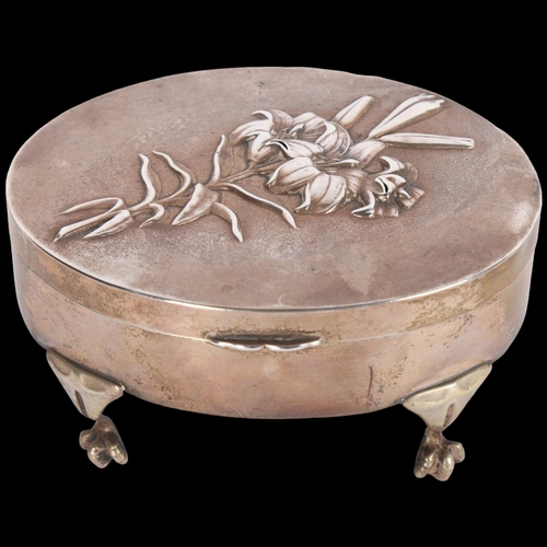 1588 - An Edwardian silver 'Lily' dressing table jewellery box, William Comyns, London 1904, oval form with... 