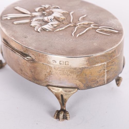 1588 - An Edwardian silver 'Lily' dressing table jewellery box, William Comyns, London 1904, oval form with... 