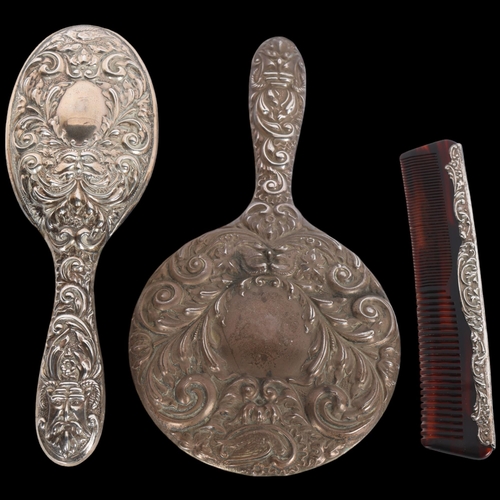 1590 - An Elizabeth II silver 3-piece 'Green Man' dressing table set, comprising hand mirror, hair brush an... 