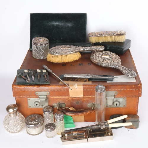 1609 - A late Victorian tan leather travelling vanity case, containing various silver fittings, including h... 