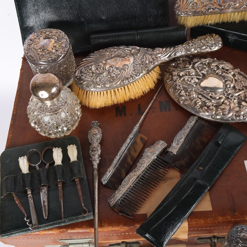 1609 - A late Victorian tan leather travelling vanity case, containing various silver fittings, including h... 