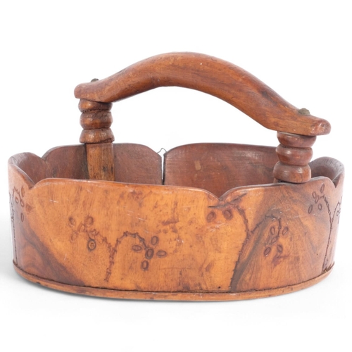 1 - PITCAIRN ISLAND - an oval red miro wood basket, with handle, shaped rim and the turned outer body wi... 