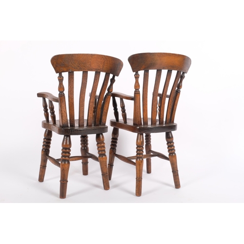 11 - A pair of reproduction elm doll's Windsor armchairs, seat height 15cm