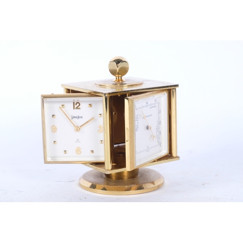 138 - NEIMAN-MARCUS - a mid-century gilt-brass desk clock and weather compendium, on revolving stand, Swis... 