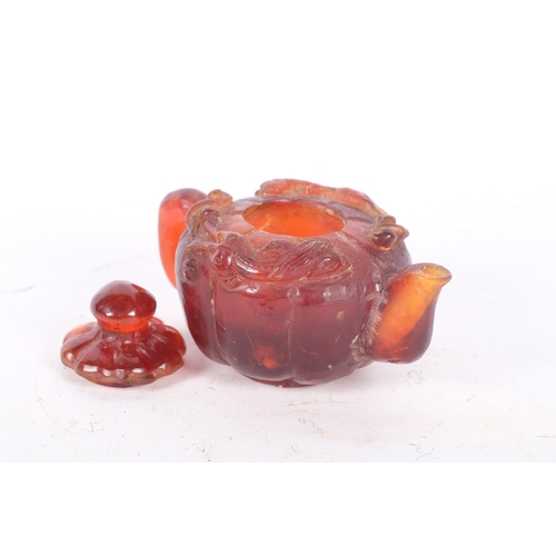 149 - A Chinese relief carved amber miniature teapot, length 10cm