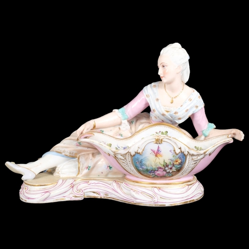 21 - MEISSEN - a large 19th century porcelain sweetmeat basket, modelled as a lady lying beside a basket ... 