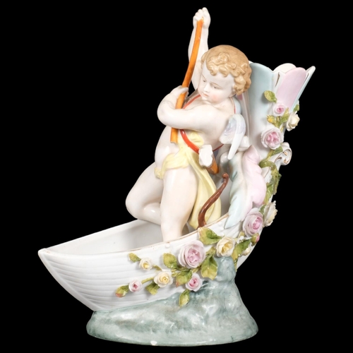 22 - MEISSEN - a 19th century porcelain bud vase, modelled as Cupid in a boat, overpainted underglaze blu... 