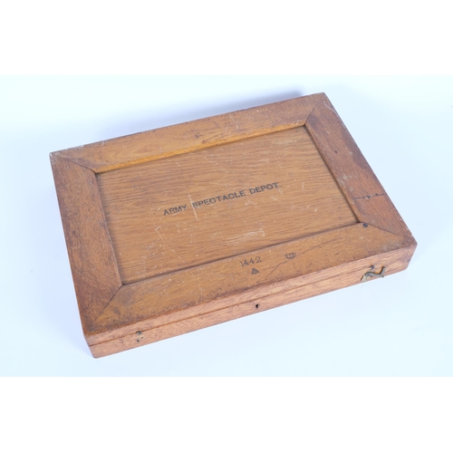 25 - A First World War Period British Military Army Spectacle Depot eye testing kit, rectangular oak case... 