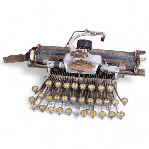 26 - An early 20th century American Blick aluminium featherweight portable typewriter, in fitted stained ... 