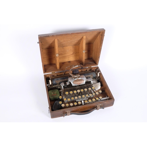 26 - An early 20th century American Blick aluminium featherweight portable typewriter, in fitted stained ... 