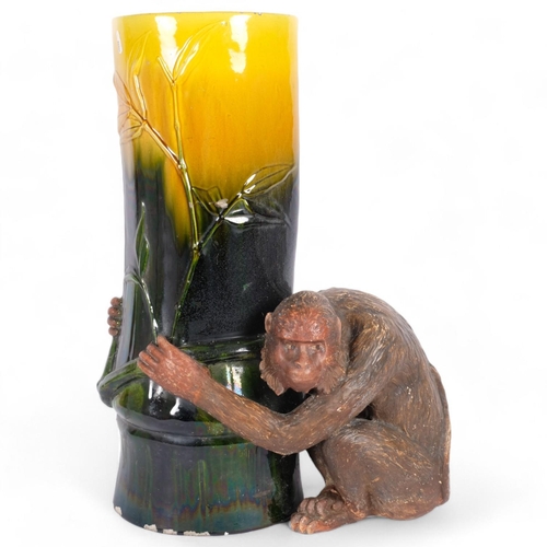 31 - A large Majolica Bretby pottery monkey umbrella stand, in the form of a monkey holding a tree trunk ... 