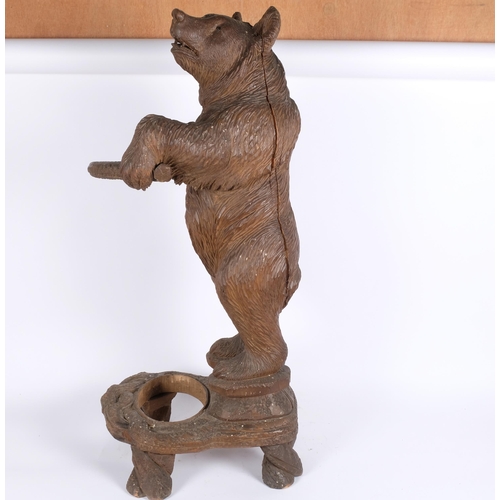 44 - A late 19th century German Black Forest bear stick stand, modelled standing upright with original gl... 