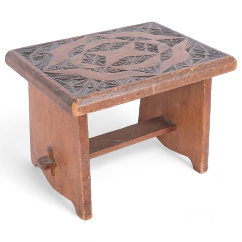 55 - A small chip carved oak stool, H22cm, W30cm, D23cm