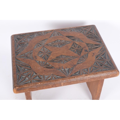 55 - A small chip carved oak stool, H22cm, W30cm, D23cm