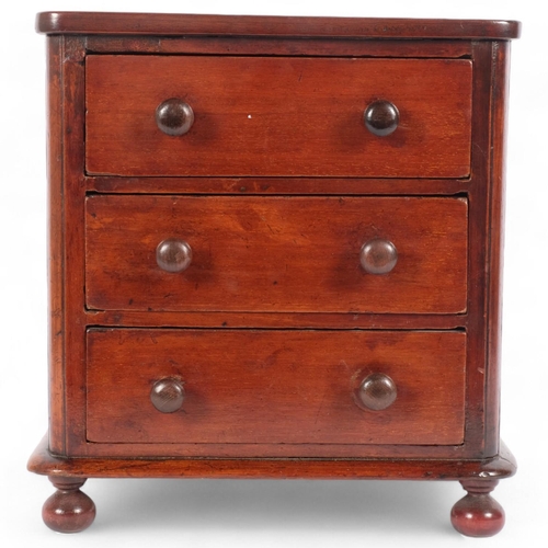 6 - A 19th century mahogany apprentice-piece table-top chest of drawers, 3 drawers raised on bun feet, H... 