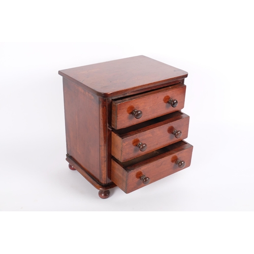 6 - A 19th century mahogany apprentice-piece table-top chest of drawers, 3 drawers raised on bun feet, H... 