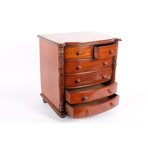 8 - A large 19th century mahogany apprentice-piece table-top bow-front chest of drawers, 2 short and 4 l... 