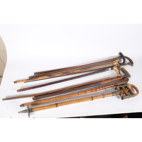 83 - A quantity of Antique walking sticks, ceremonial sword, bamboo shooting stick, etc (9)