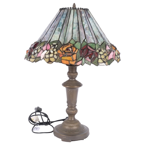 429 - An embossed brass table lamp, with Tiffany style leadlight shade with floral frieze, H58cm