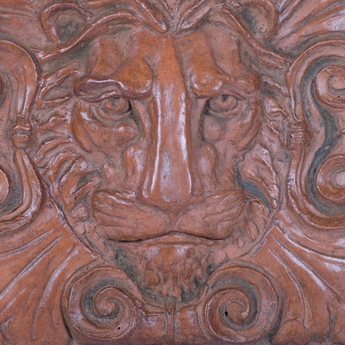 466 - A moulded terracotta finished lion mask wall plaque with hanger, H30cm