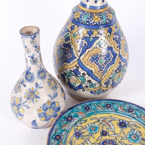 475 - An Iznik bottle vase with painted design (some damage), 31cm, a wall plaque with floral decoration, ... 