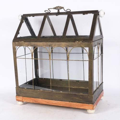 633 - An unusual greenhouse design metal and glass terrarium, on wooden base with china feet, L46cm