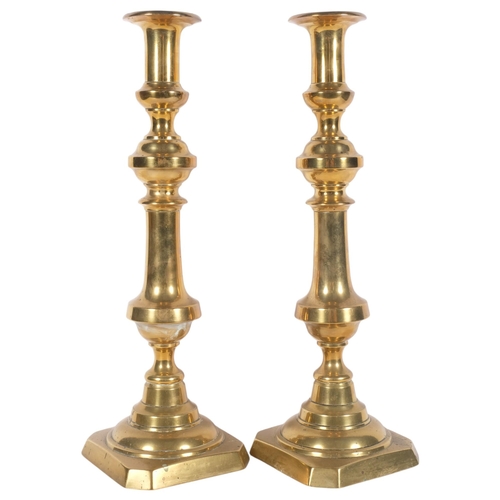 634 - A large pair of Antique turned brass ejector candlesticks