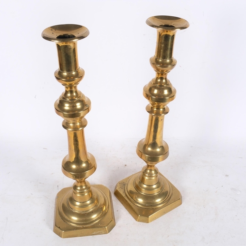 634 - A large pair of Antique turned brass ejector candlesticks