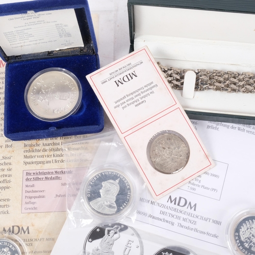 667 - Various silver coins, a silver chain bracelet, etc