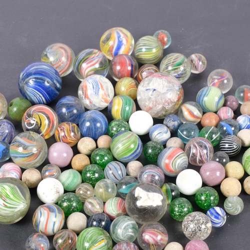 668 - A collection of 19th and 20th century glass marbles, including latticino and Victorian sulphide exam... 