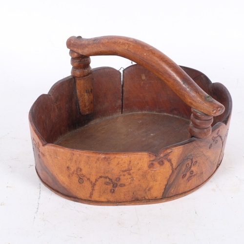 1 - PITCAIRN ISLAND - an oval red miro wood basket, with handle, shaped rim and the turned outer body wi... 