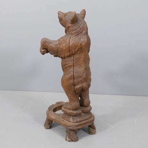 44 - A late 19th century German Black Forest bear stick stand, modelled standing upright with original gl... 